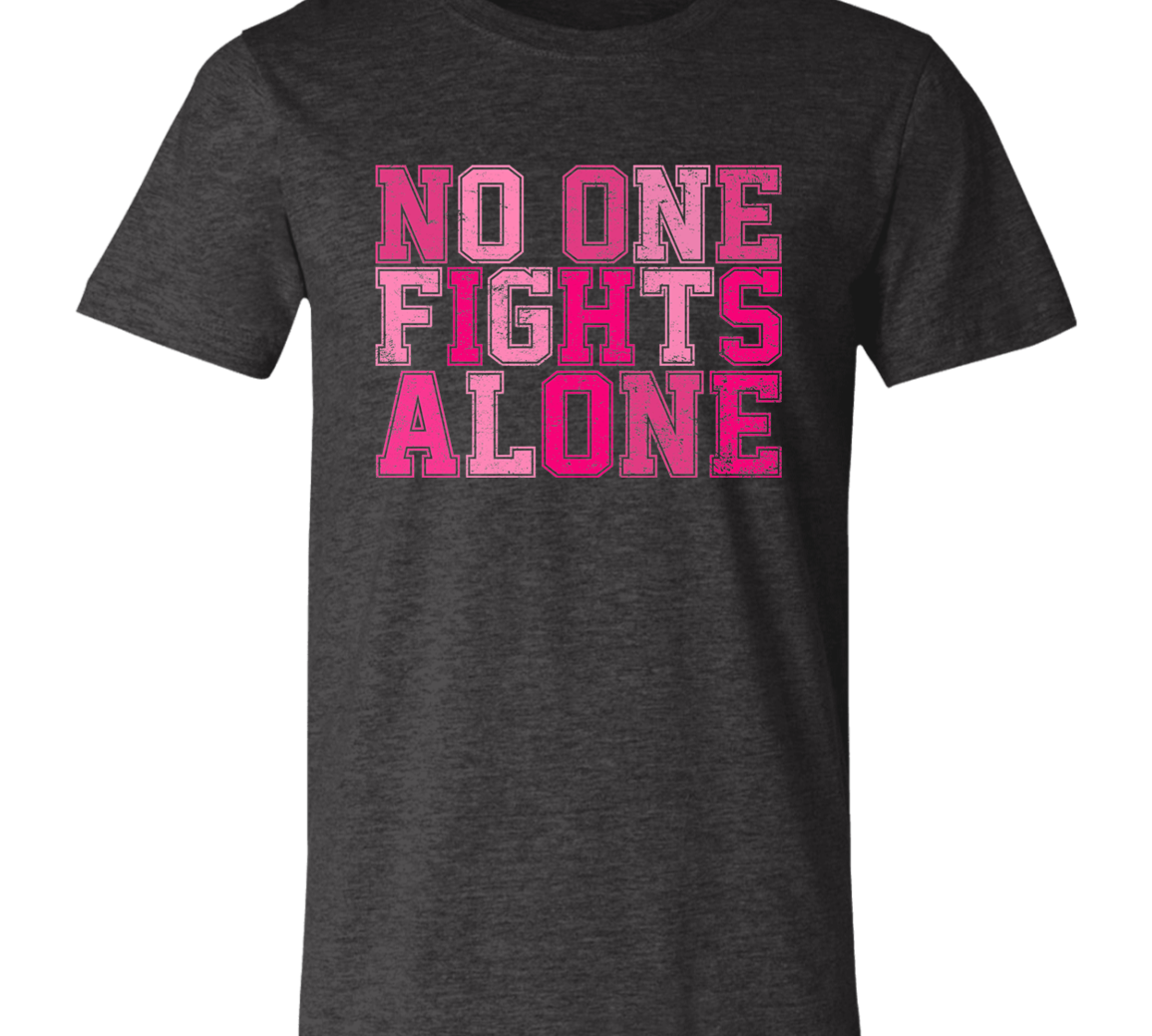 dk heather grey short sleeve t-shirt with block letters in pink that say, "No one fights alone".