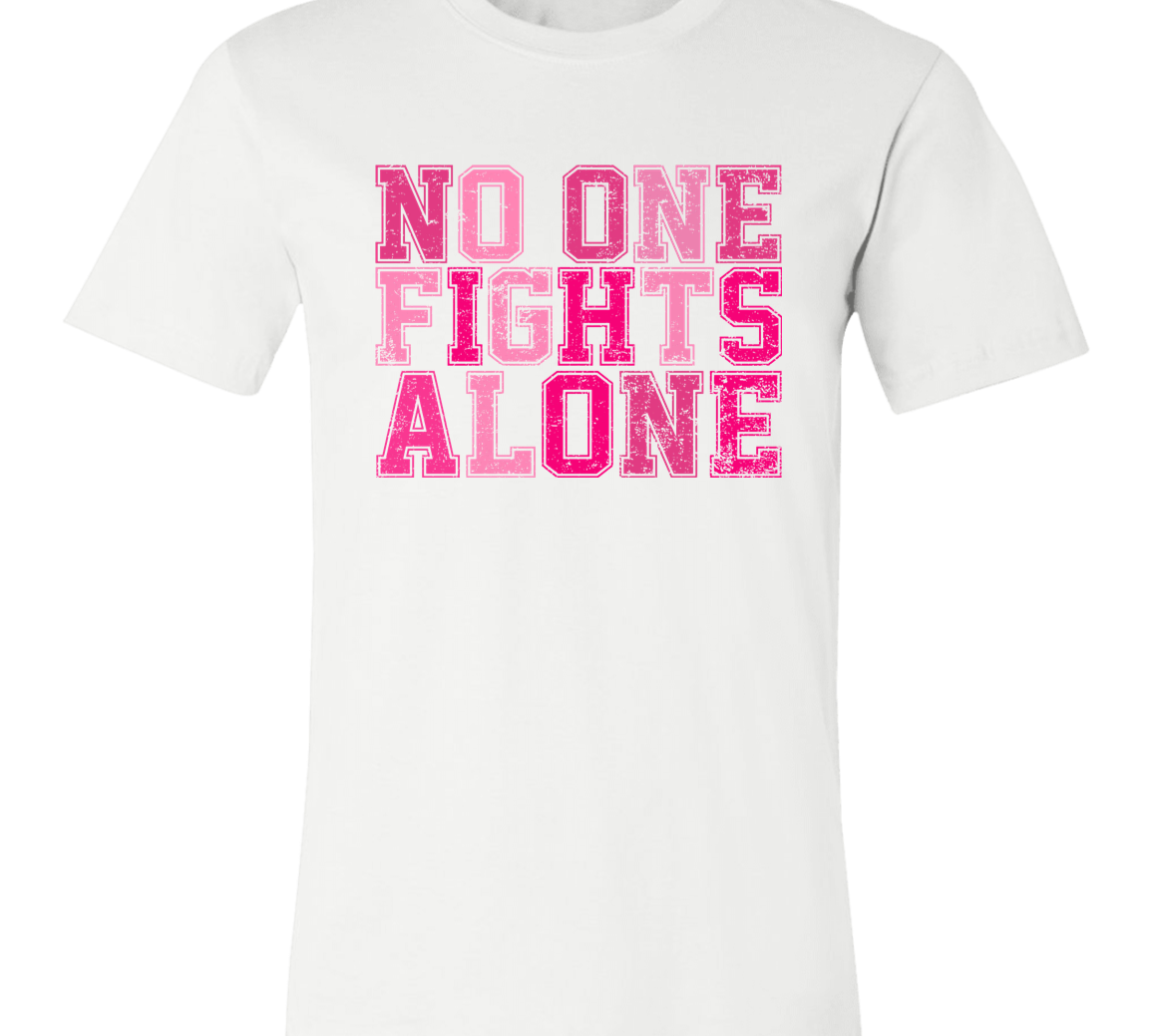 white short sleeve t-shirt with block letters in pink that say, "No one fights alone".
