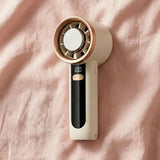 A pink and white rechargeable handheld fan, compact enough for a purse, used for hot flash relief during breast cancer treatment.