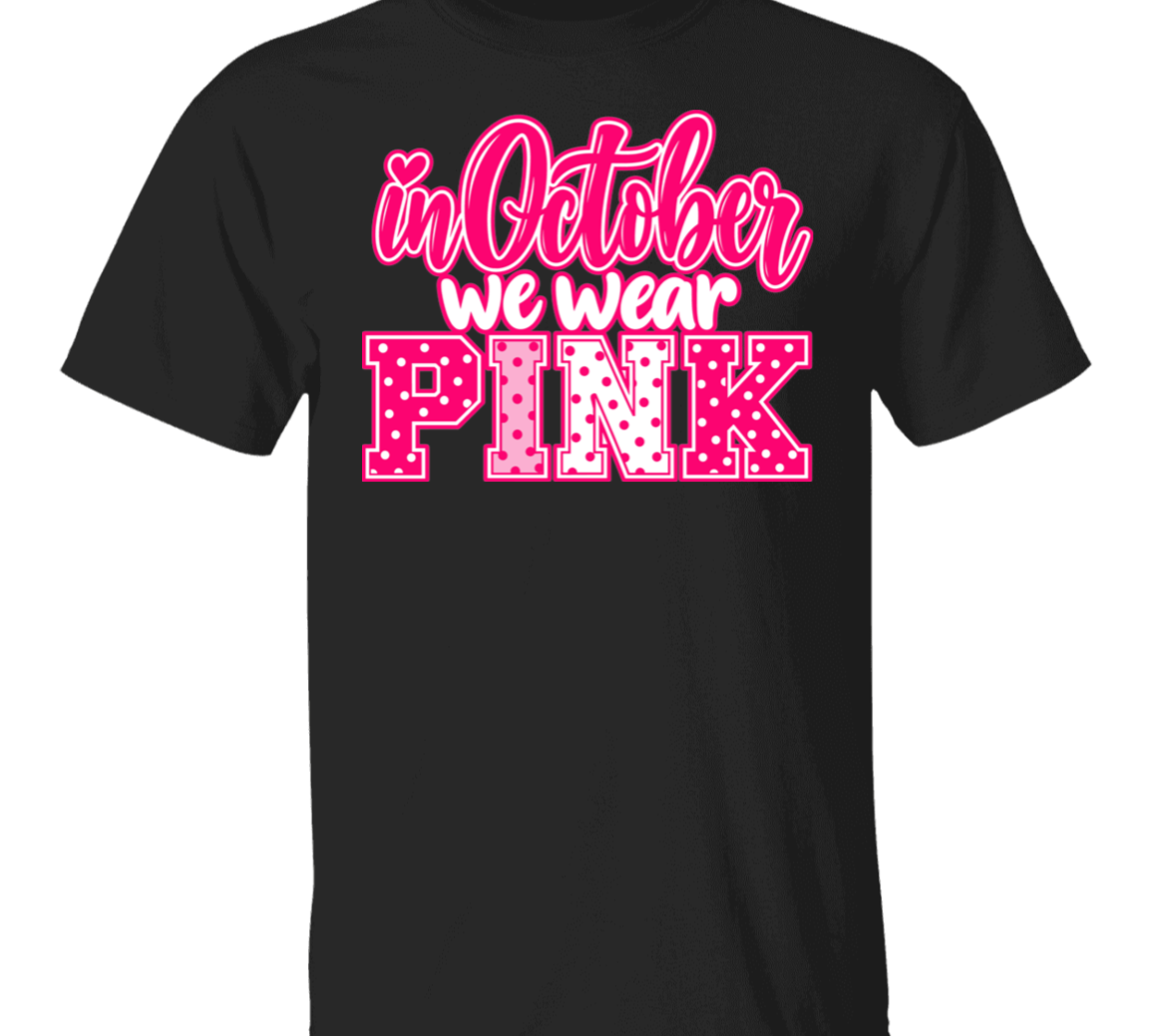 black tshirt with the words, "in October we wear Pink" with the letters in pink and white polka dots.