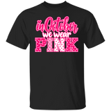 black tshirt with the words, "in October we wear Pink" with the letters in pink and white polka dots.