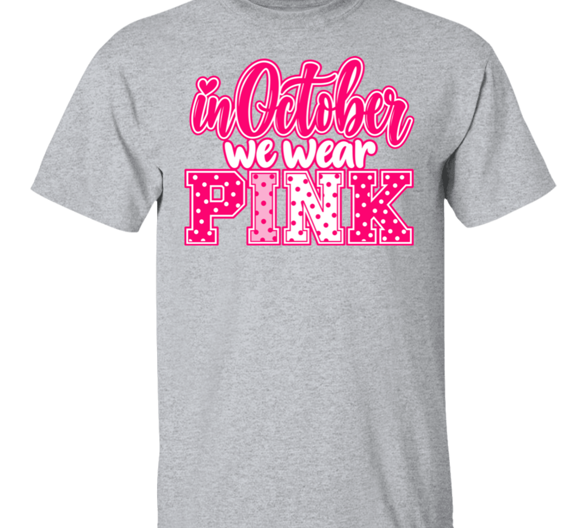 heather grey tshirt with the words, "in October we wear Pink" with the letters in pink and white polka dots.
