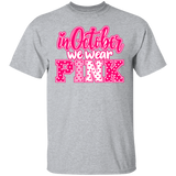 heather grey tshirt with the words, "in October we wear Pink" with the letters in pink and white polka dots.