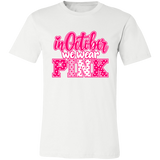 a white graphic t-shirt that reads 'in October we wear PINK' in pink and white lettering
