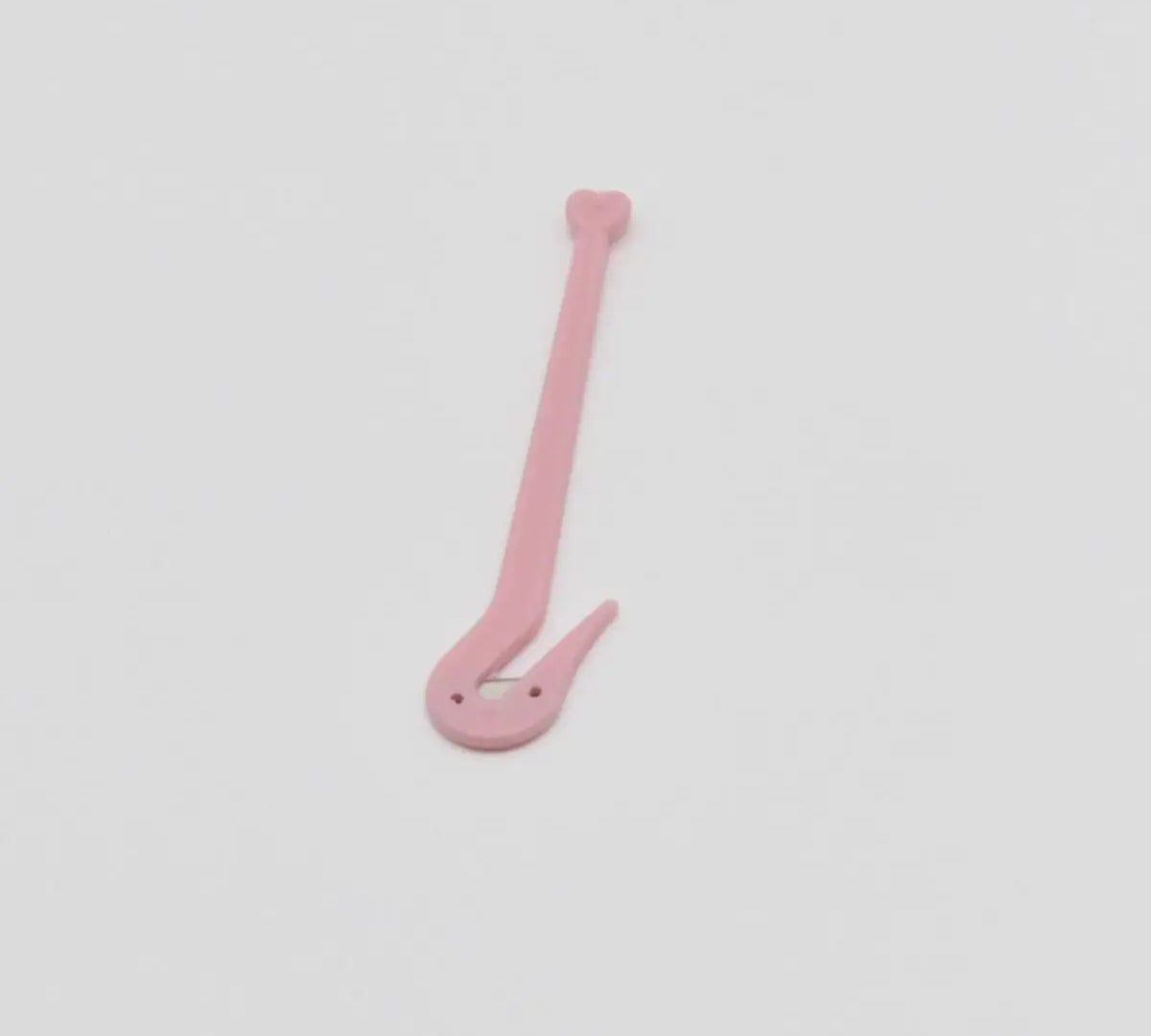 A small handheld medical wristband cutter, a safety tool for removing a hospital ID band after an appointment or surgery.