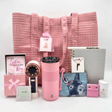 The Pink Luxe Box open and styled, showing 13 comfort, beauty, and recovery essentials curated for a woman facing breast cancer.