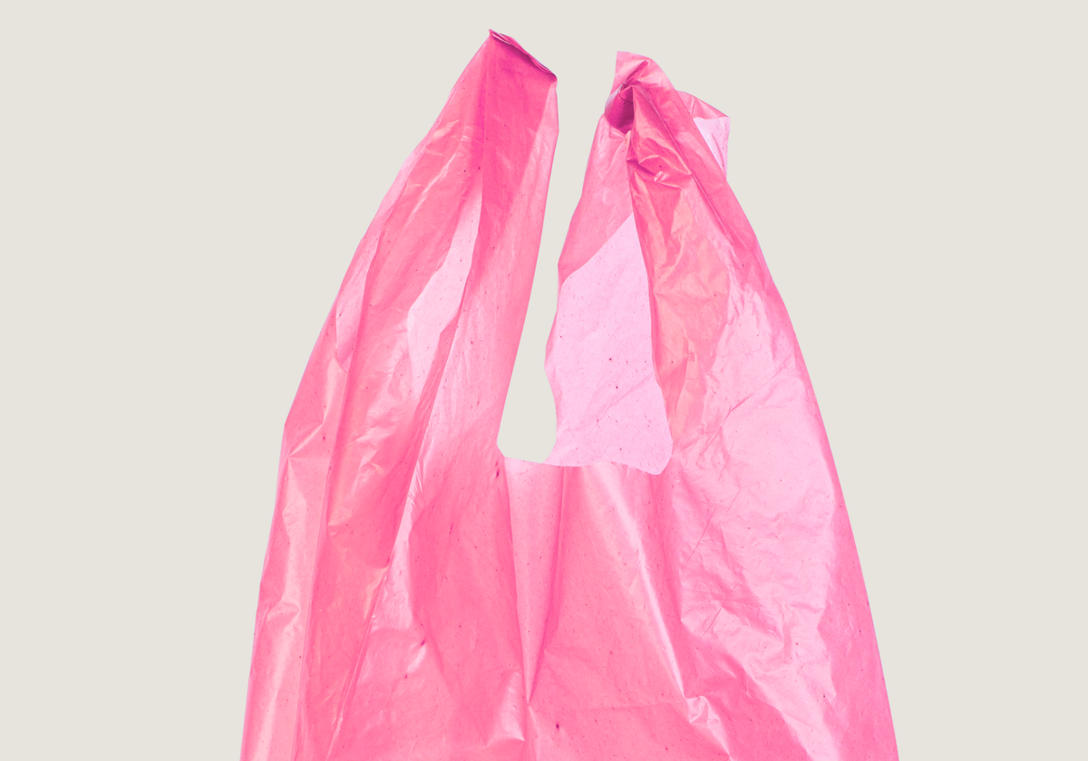 A crinkled translucent pink plastic bag shown against a plain light gray background.